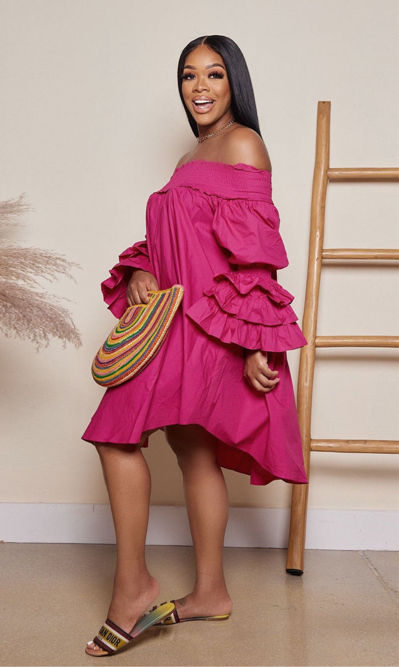 This midi length dress features an off shoulder design and oversized ruffle sleeves .