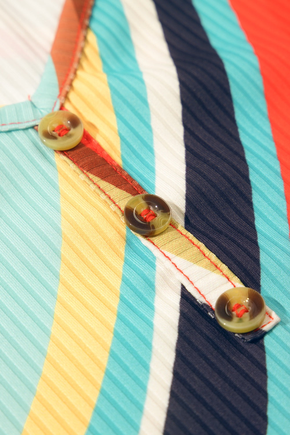 Close-up of a colorful striped shirt with buttons