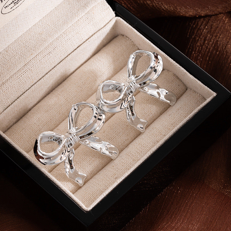 Silver Ribbon Bow Statement Earrings – Elegant Sculpted Metal Design