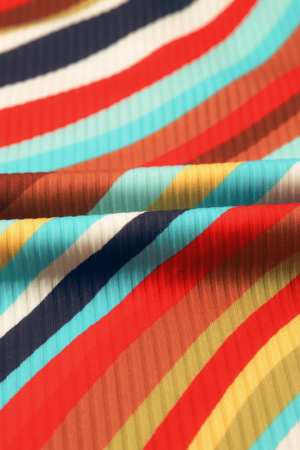 Close-up of fabric with multicolored stripes in red, blue, yellow, and white.