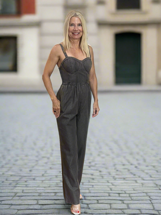 This gray denim, this jumpsuit features a flattering acid wash and a wide leg design smocked back and adjustable button straps