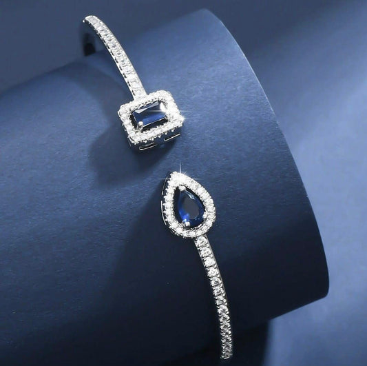 Sapphire Inspired Bangle Bracelet. Dazzling cubic zirconia with pear shape and emerald shape stones
