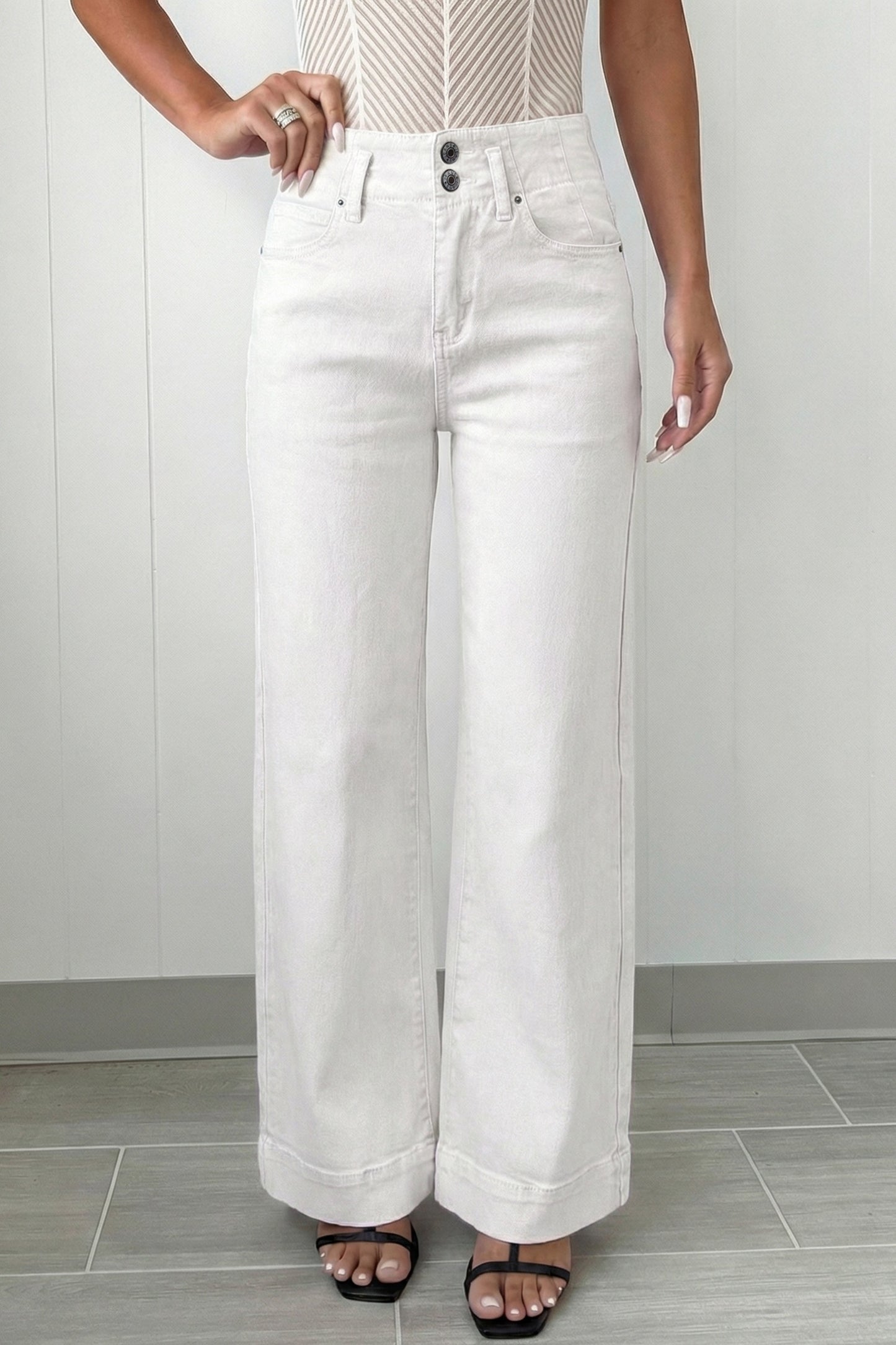 Person wearing white wide-leg jeans 