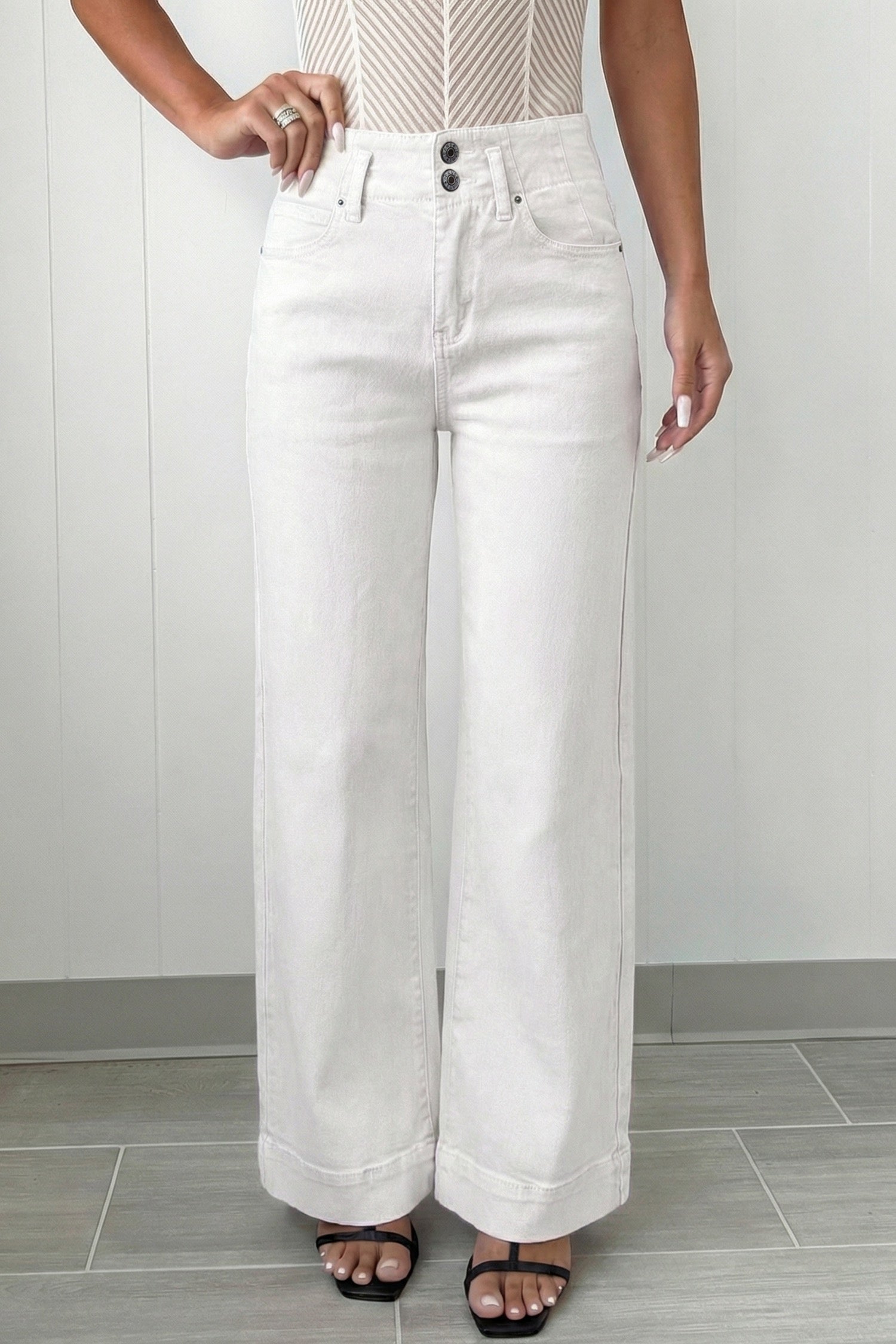Person wearing white wide-leg jeans 