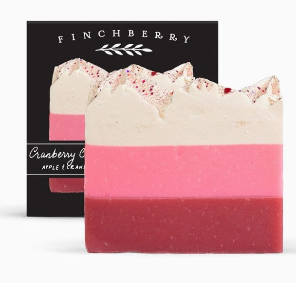 Two layered soap bar with pink and red colors in front of a black Finchberry packaging.