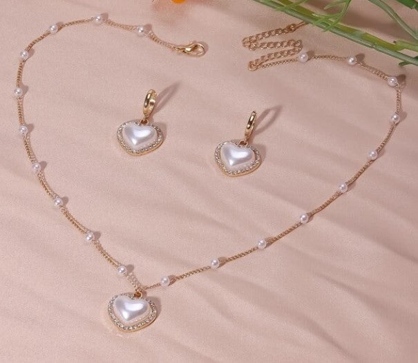 Pearl shape heart necklace with pearl and gold chain with matching pearl heart earrings with rhinestones