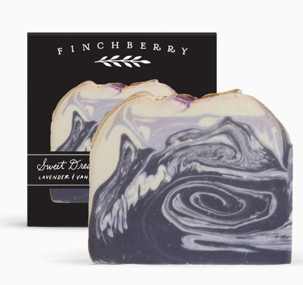 Swirl-patterned soap bar with Finchberry packaging in the background